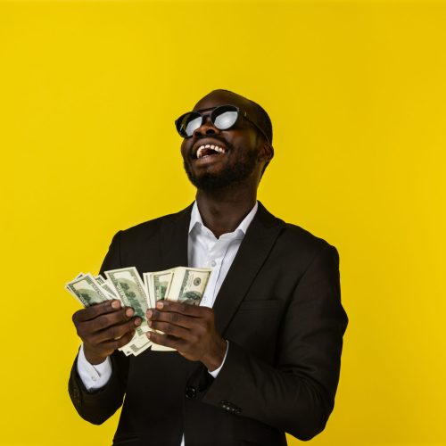 Happy cool African man enjoys the money